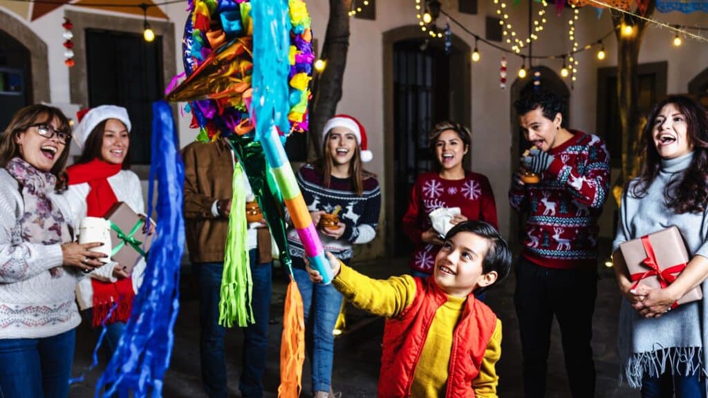 Mexican family playing with a pinata at Christmas time